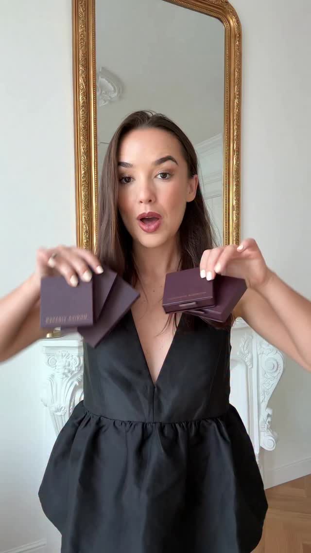 Monica Vinader creator video ad still: a creator holding jewelry boxes in front of a mirror, styling pieces from the Black Friday sale