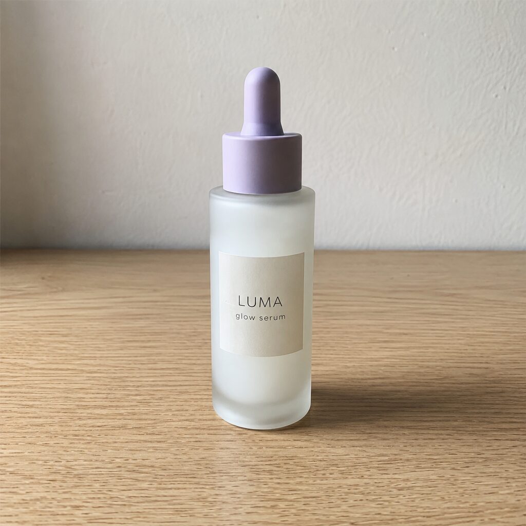 Phone photo of a serum bottle on a wooden table